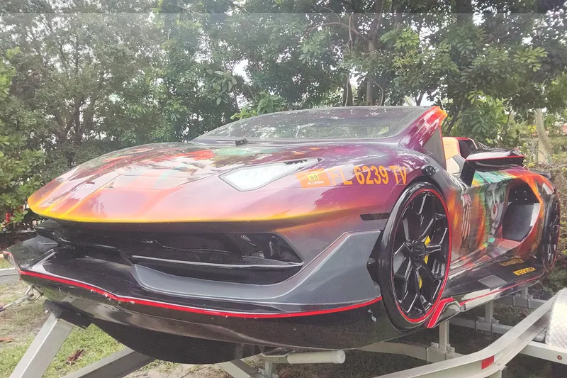 Slide: The Image of 2024 Watersports Car SERIES-L with vibrant design on display outdoors. - 2