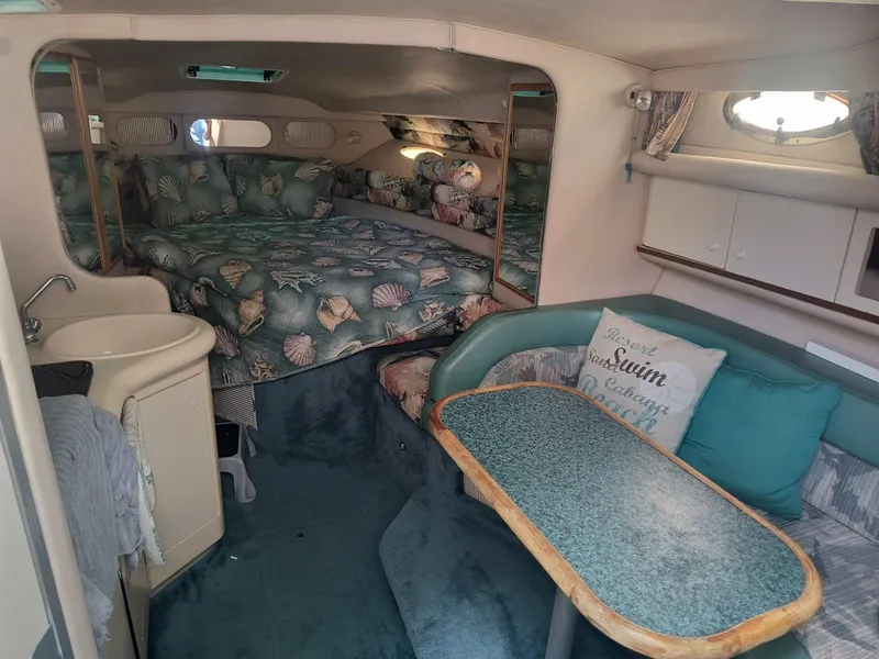 Slide: The Image of Interior of 1995 Sea Ray 330 Sundancer with cozy seating and nautical decor. - 10