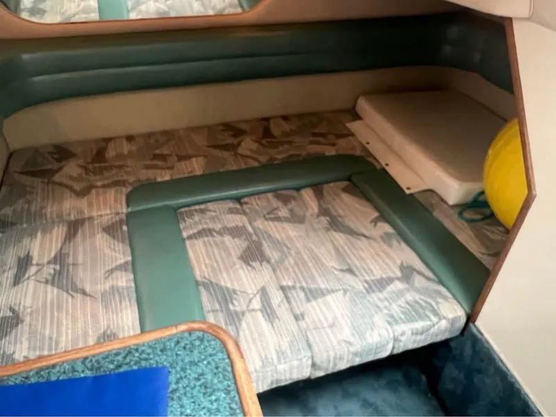 Slide: The Image of 1995 Sea Ray 330 Sundancer cabin interior with patterned upholstery and teal accents. - 13