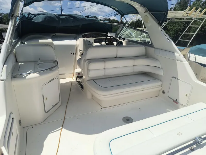 Slide: The Image of 1995 Sea Ray 330 Sundancer boat interior with white seating and canopy. - 4