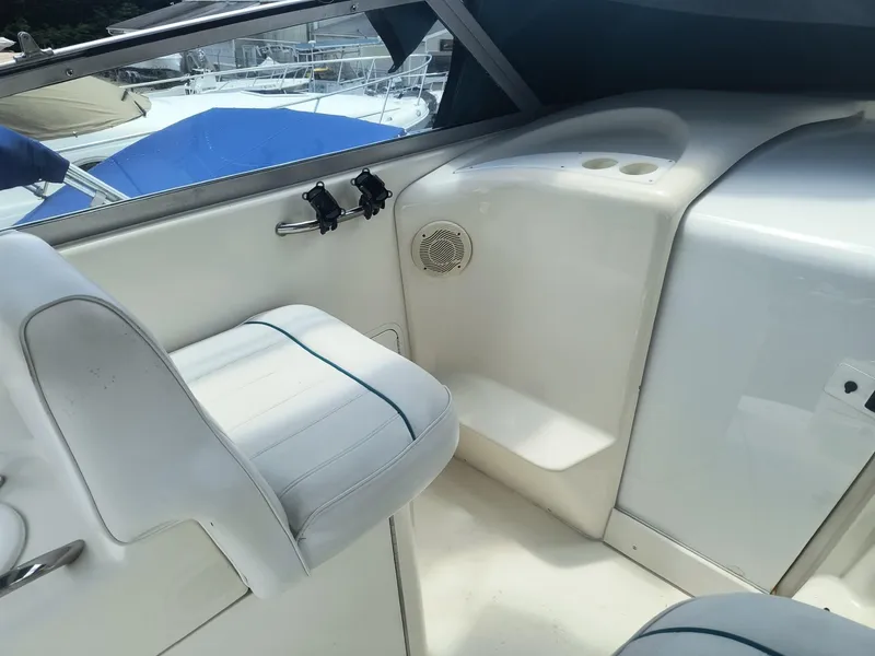 Slide: The Image of 1995 Sea Ray 330 Sundancer cockpit with white seating and speaker. - 7