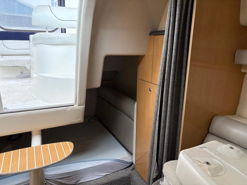 Slide: The Image of Interior of 2004 Maxum 3100 SE boat, featuring seating and cabin area. - 18