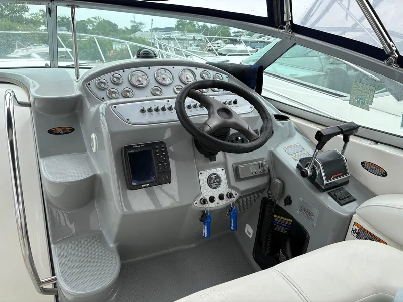 Slide: The Image of 2004 Maxum 3100 SE boat cockpit with steering wheel and control panel. - 3