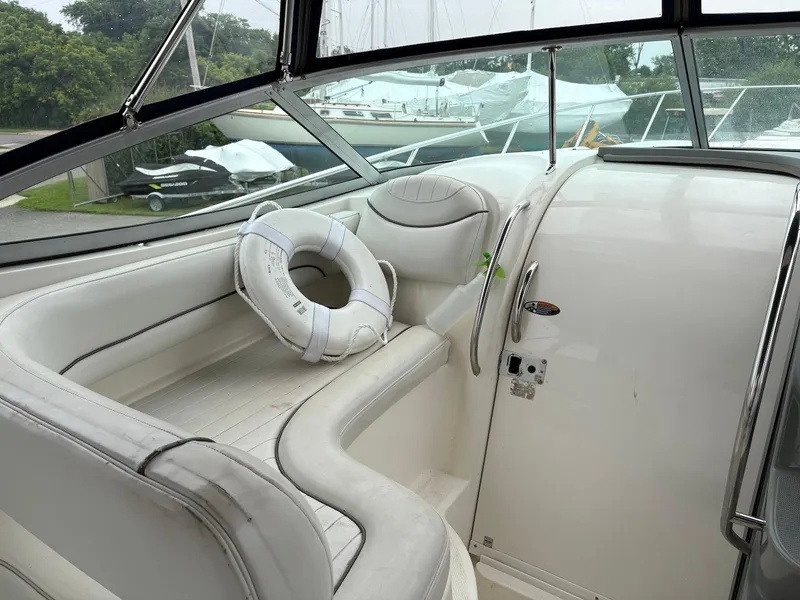 Slide: The Image of 2004 Maxum 3100 SE boat interior with white seating and life preserver. - 6
