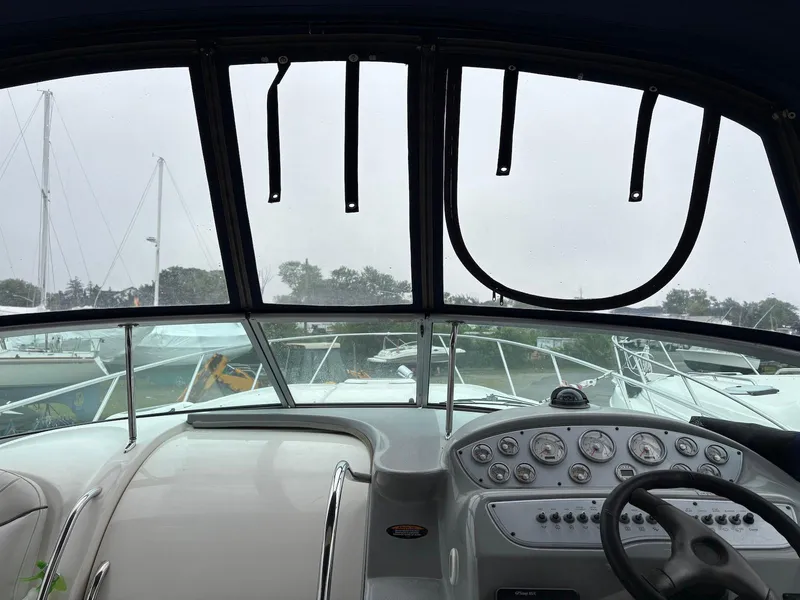 Slide: The Image of Interior view of 2004 Maxum 3100 SE boat cockpit with steering wheel and control panel. - 7