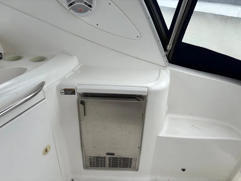 Slide: The Image of 2004 Maxum 3100 SE boat interior with mini fridge and speaker. - 8
