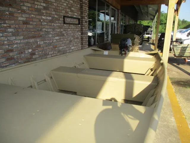 Slide: The Image of 2025 Crestliner CR1448 Jon Boat displayed outdoors, featuring a durable design and motor. - 3