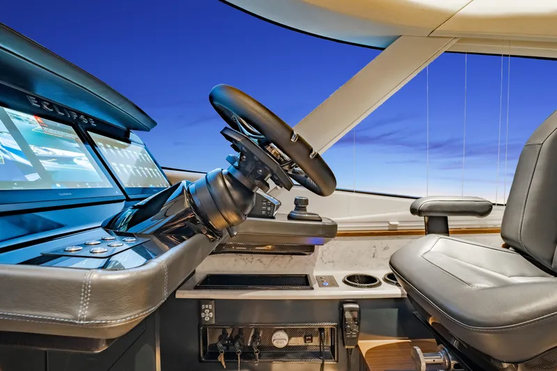 Slide: The Image of Helm of 2025 ECLIPSE 505 Shadow yacht with modern controls and leather seating. - 11