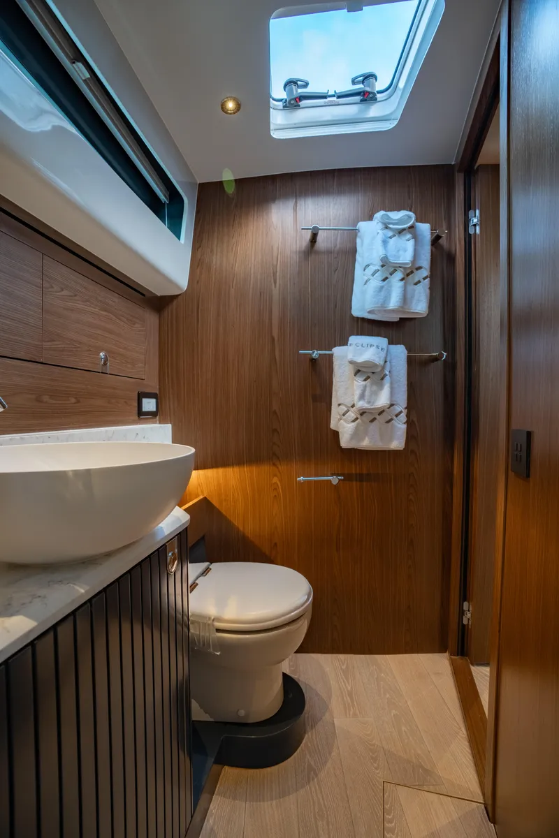 Slide: The Image of Luxurious bathroom in 2025 ECLIPSE 505 Shadow yacht with modern fixtures and wooden accents. - 22