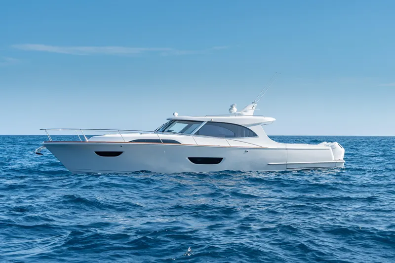 Slide: The Image of 2025 ECLIPSE 505 Shadow yacht cruising on open sea under clear blue sky. - 23