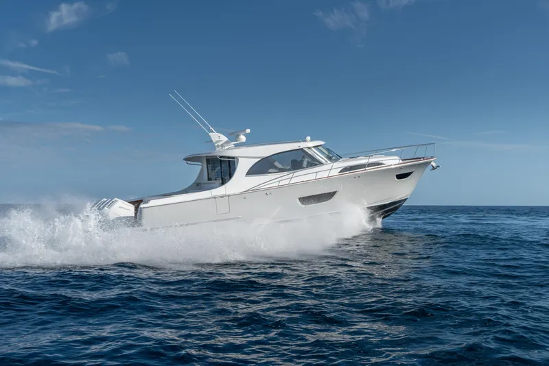 Slide: The Image of 2025 ECLIPSE 505 Shadow yacht cruising on open sea under clear blue sky. - 29