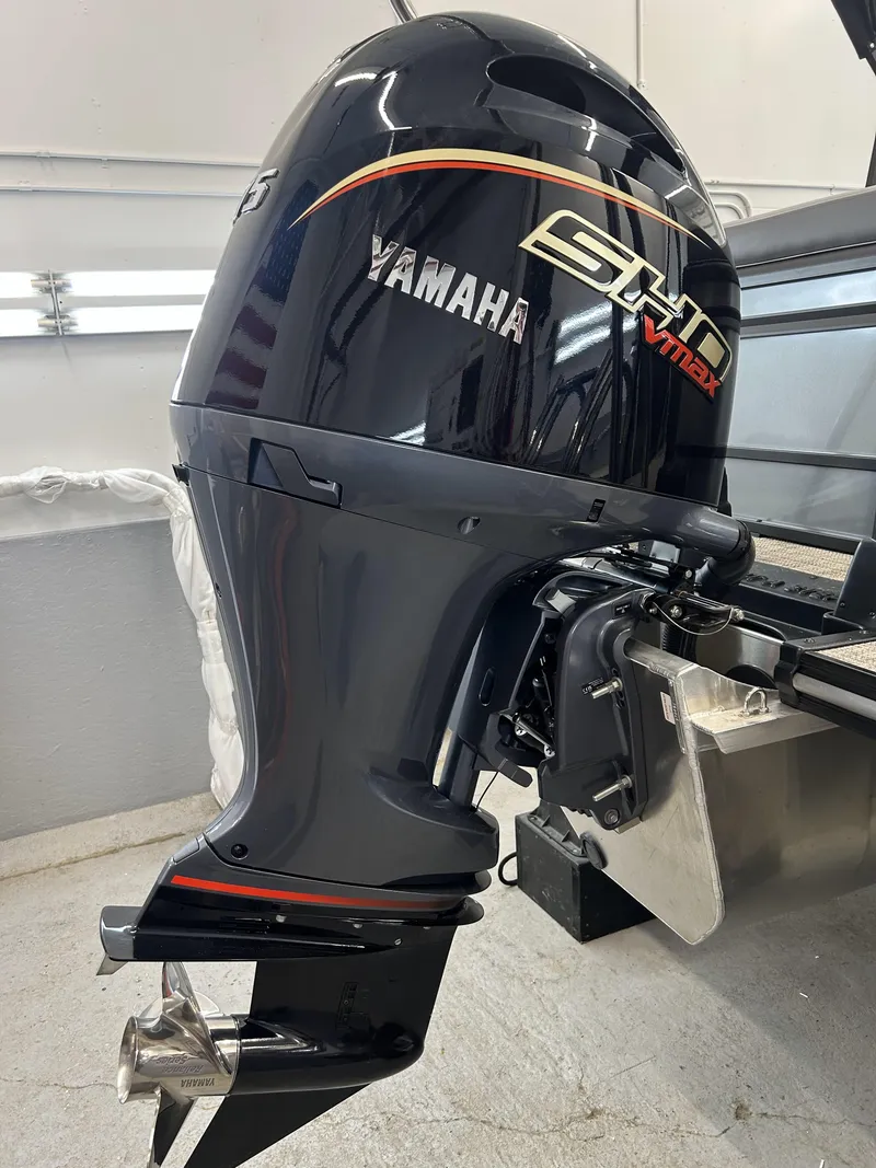 Slide: The Image of 2025 SunCatcher Fusion 322C with Yamaha VMAX outboard motor in a garage setting. - 10