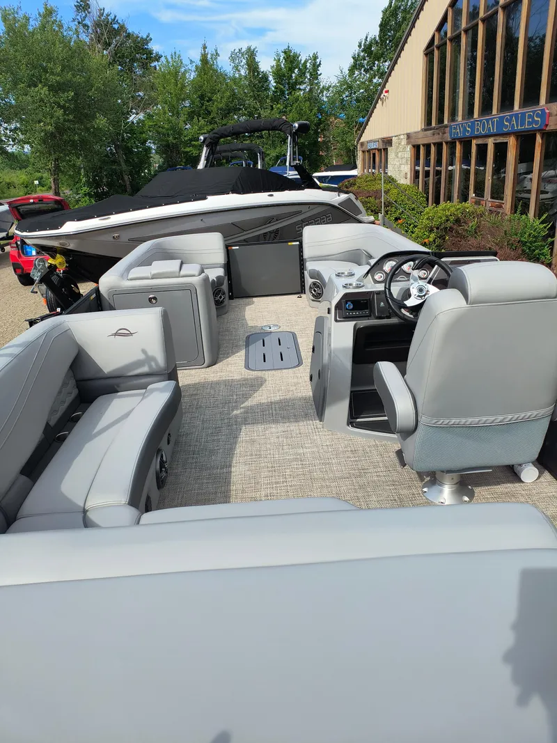Slide: The Image of 2025 SunCatcher Fusion 322C pontoon boat interior with modern seating and steering console. - 11