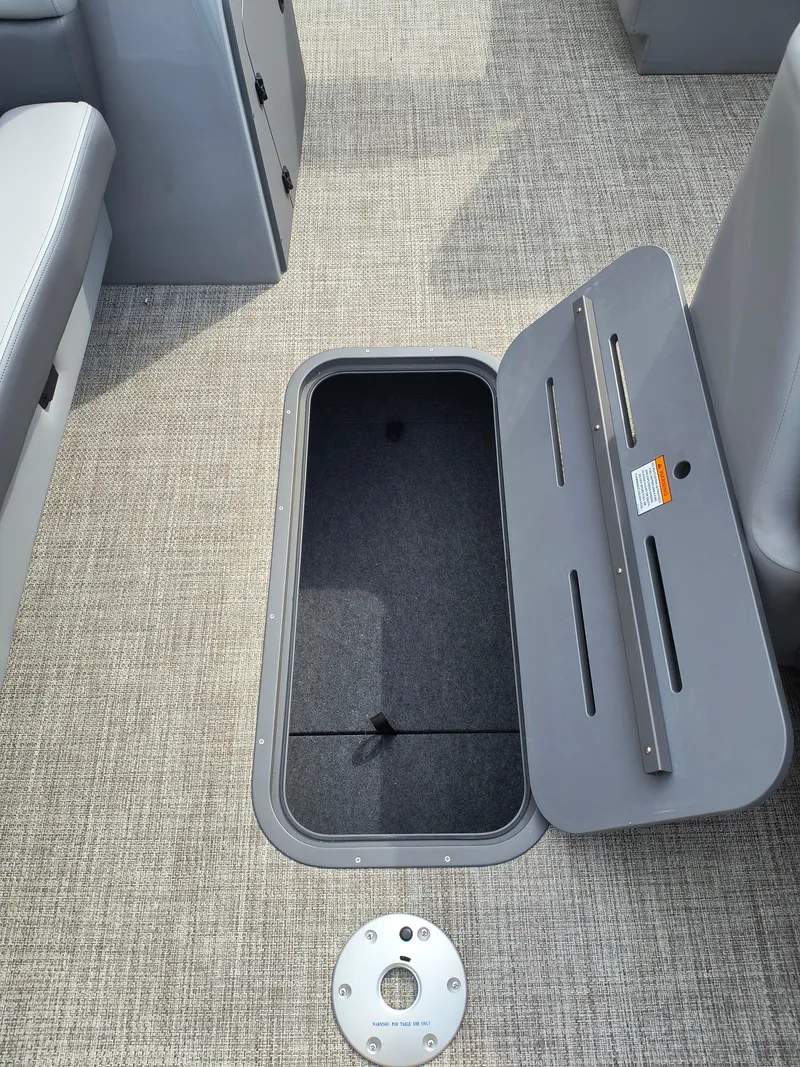 Slide: The Image of Open storage compartment on 2025 SunCatcher Fusion 322C boat with gray interior. - 13
