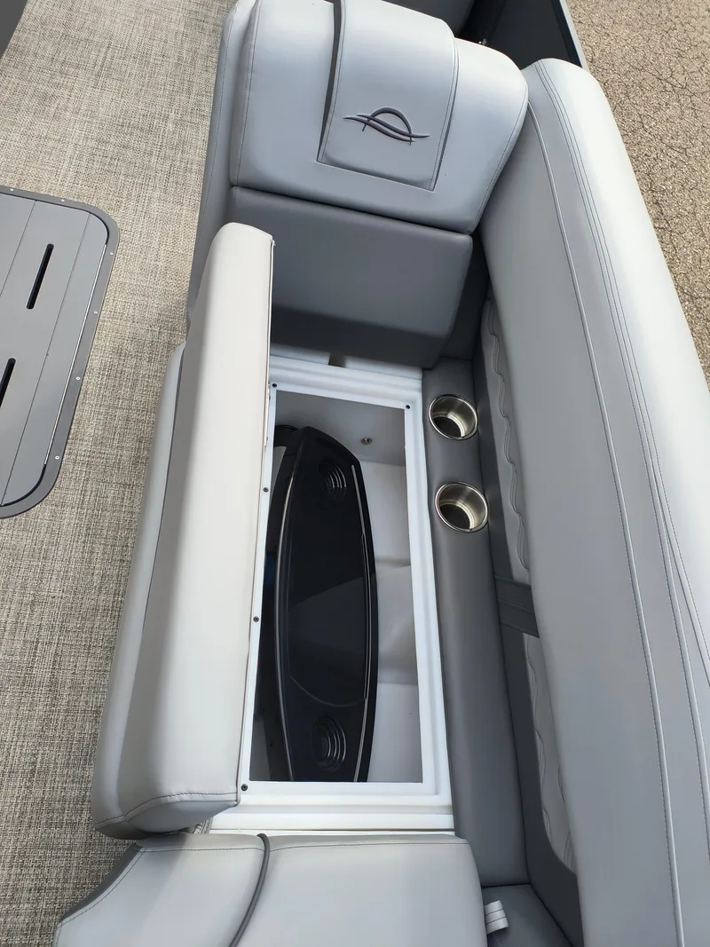 Slide: The Image of 2025 SunCatcher Fusion 322C boat seat with storage compartment and cup holders. - 15