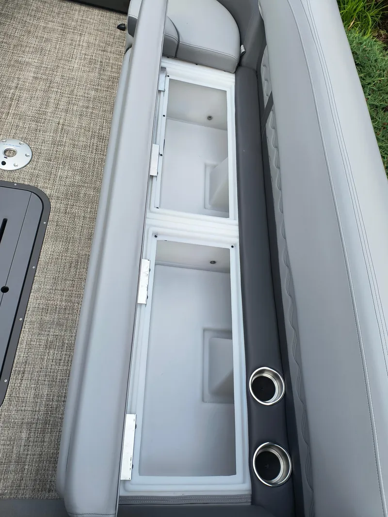 Slide: The Image of 2025 SunCatcher Fusion 322C boat seat storage with cup holders and gray upholstery. - 17