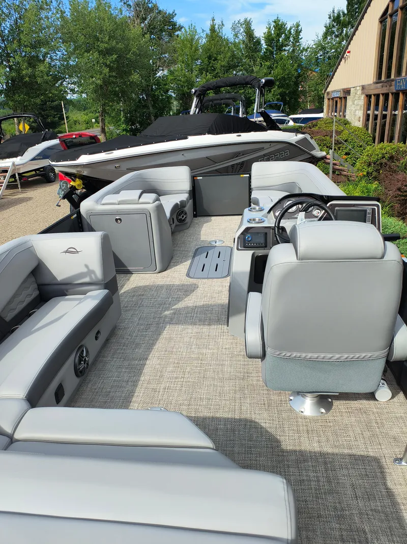 Slide: The Image of 2025 SunCatcher Fusion 322C pontoon boat interior with gray seating and modern dashboard. - 20