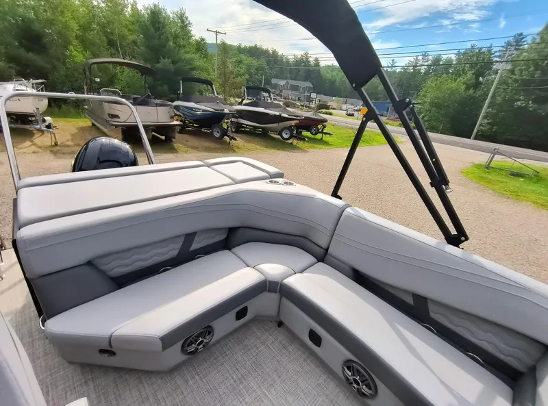 Slide: The Image of 2025 SunCatcher Fusion 322C boat interior with gray seating and outdoor view. - 22