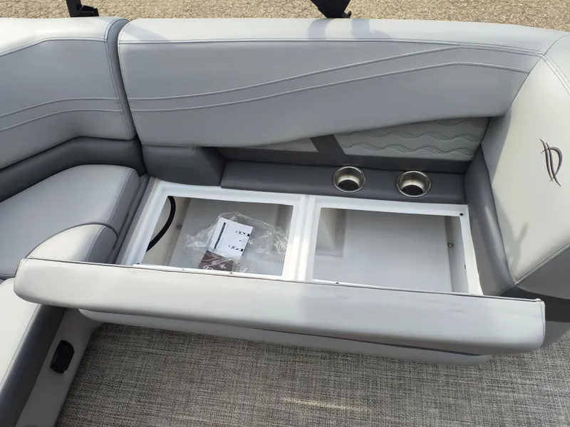 Slide: The Image of 2025 SunCatcher Fusion 322C boat seat with storage compartment and cup holders. - 24