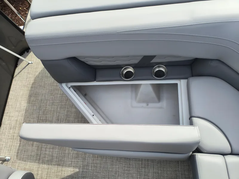 Slide: The Image of SunCatcher Fusion 322C 2025 boat seat with storage compartment and cup holders. - 25
