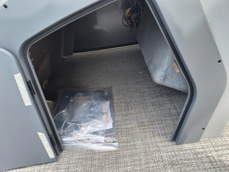 Slide: The Image of Storage compartment of 2025 SunCatcher Fusion 322C with carpeted interior and wiring. - 27