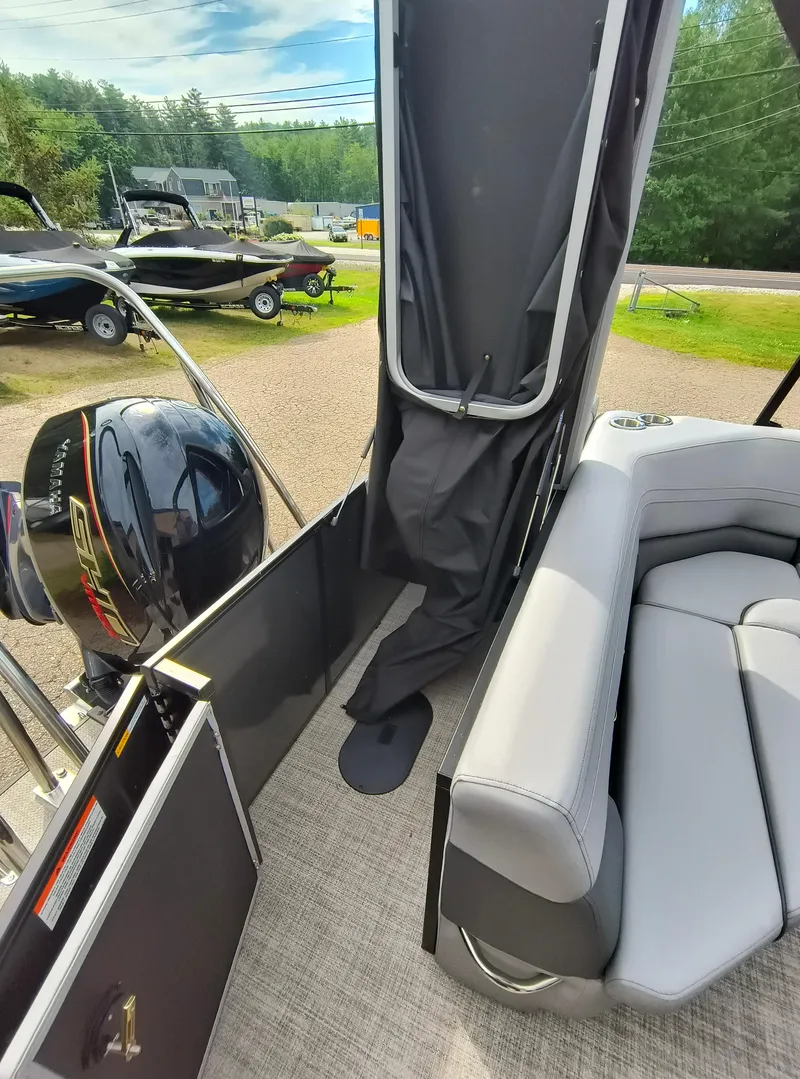 Slide: The Image of 2025 SunCatcher Fusion 322C boat interior with Yamaha engine and gray seating. - 29