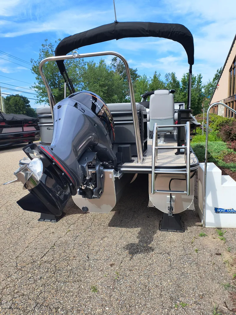 Slide: The Image of 2025 SunCatcher Fusion 322C pontoon boat with powerful outboard motor and sleek design. - 32