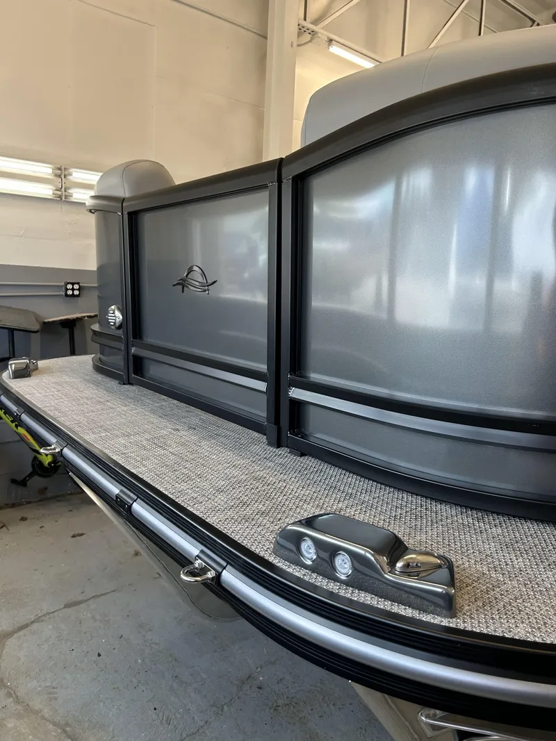 Slide: The Image of 2025 SunCatcher Fusion 322C pontoon boat in a showroom, showcasing sleek design and modern features. - 8