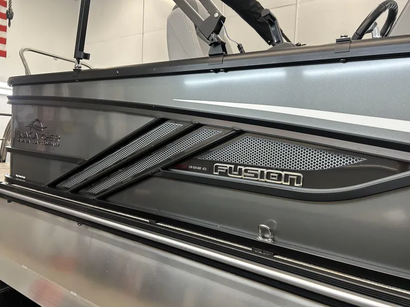 Slide: The Image of 2025 SunCatcher Fusion 322C boat, sleek design with metallic accents and branding details. - 9
