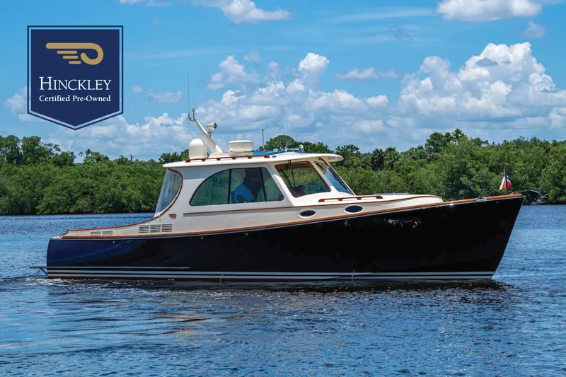Slide: The Image of 2016 Hinckley Picnic Boat 37 MKIII on water, certified pre-owned, under blue sky. - 0