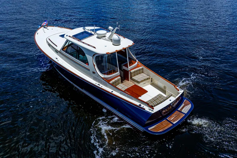 Slide: The Image of 2016 Hinckley Picnic Boat 37 MKIII cruising on open water, showcasing elegant design. - 1