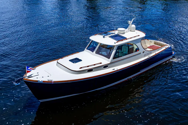 Slide: The Image of 2016 Hinckley Picnic Boat 37 MKIII cruising on calm blue water. - 23