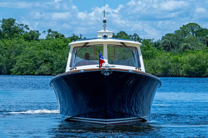 Slide: The Image of 2016 Hinckley Picnic Boat 37 MKIII cruising on a serene lake. - 25