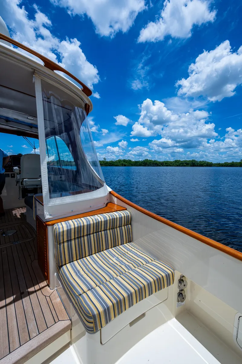 Slide: The Image of 2016 Hinckley Picnic Boat 37 MKIII on serene water under a vibrant blue sky. - 6