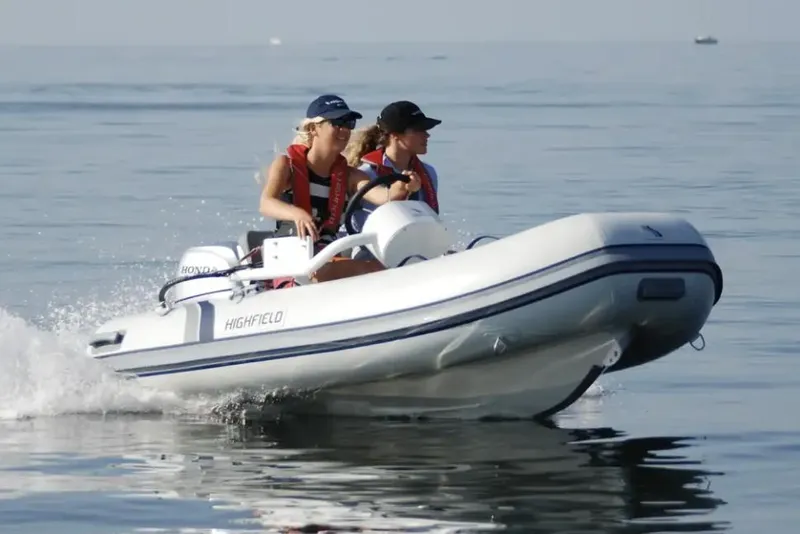 The Image of 2024 Highfield Classic 340 FCT boat with two people cruising on calm water. - 0