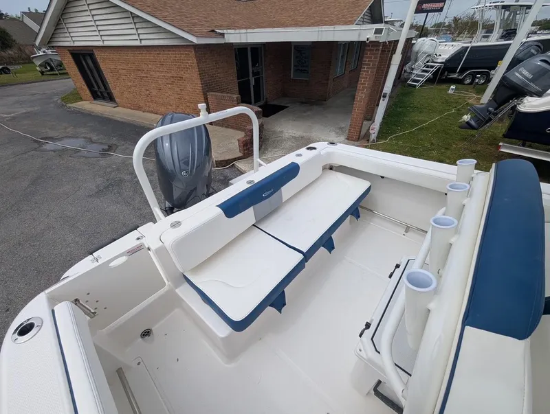 Slide: The Image of 2025 Robalo R222 Explorer boat interior with seating and rod holders. - 29