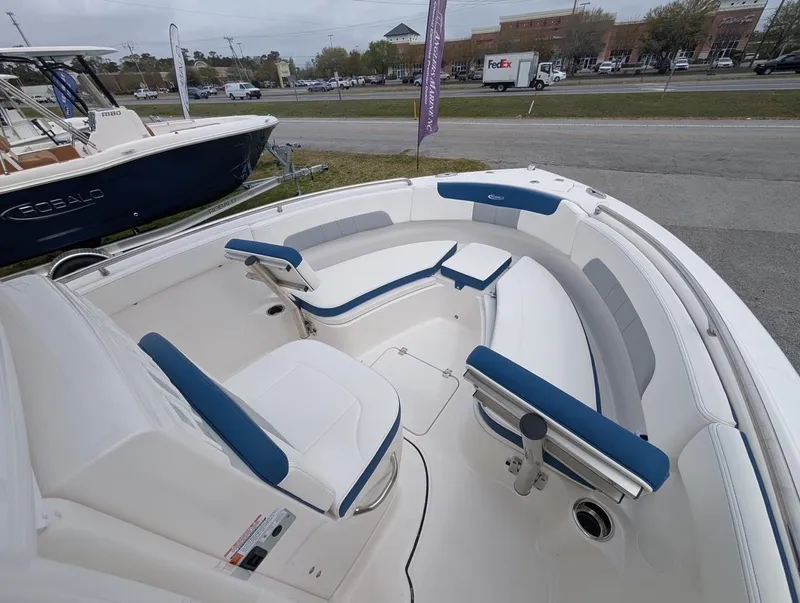 Slide: The Image of 2025 Robalo R222 Explorer boat interior with blue and white seating. - 31