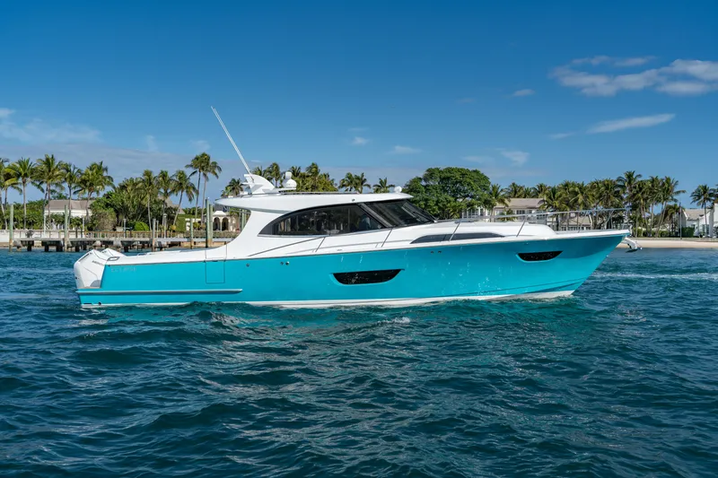 The Image of 2025 ECLIPSE 505 Shadow yacht on blue water, palm trees in background. - 0