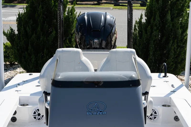 Slide: The Image of 2026 Blazer 675 Ultimate Bay boat with dual seats and powerful outboard motor. - 14