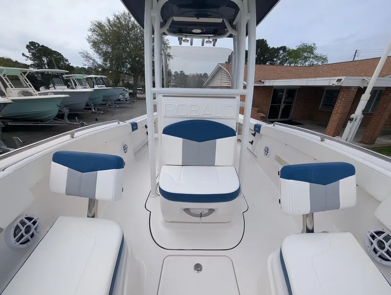 Slide: The Image of 2025 Robalo R222 Explorer boat interior with blue and white seating. - 23