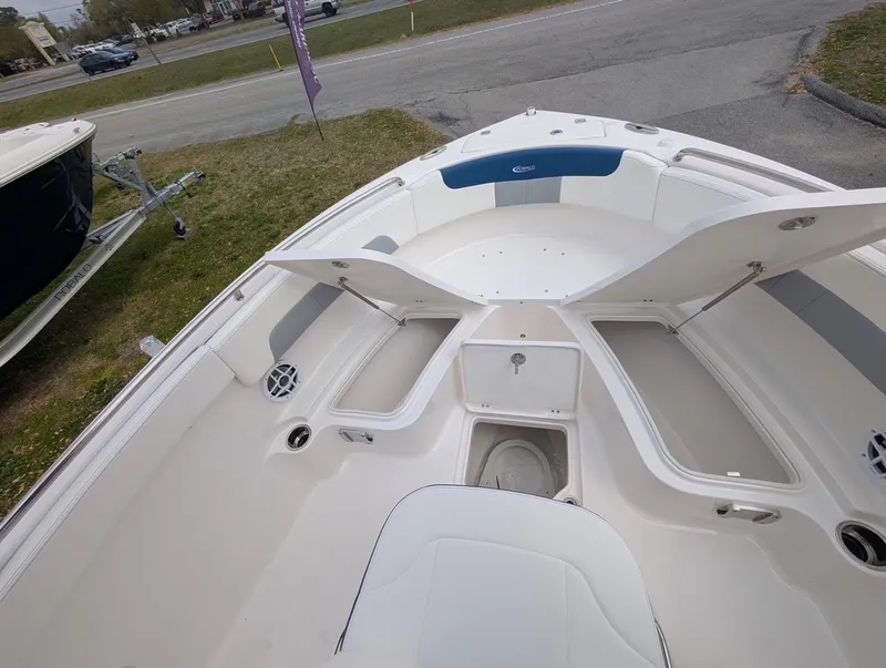 Slide: The Image of 2025 Robalo R222 Explorer boat interior with open storage compartments and seating. - 26