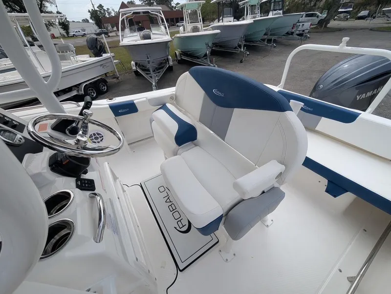 Slide: The Image of 2025 Robalo R222 Explorer boat interior with steering wheel and seating. - 27