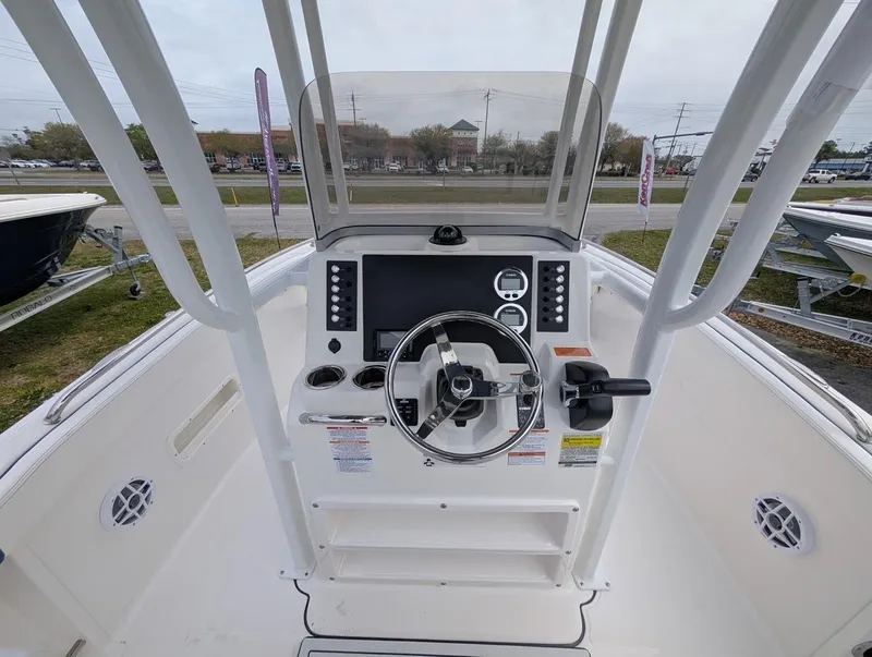 Slide: The Image of 2025 Robalo R222 Explorer boat console with steering wheel and controls. - 33