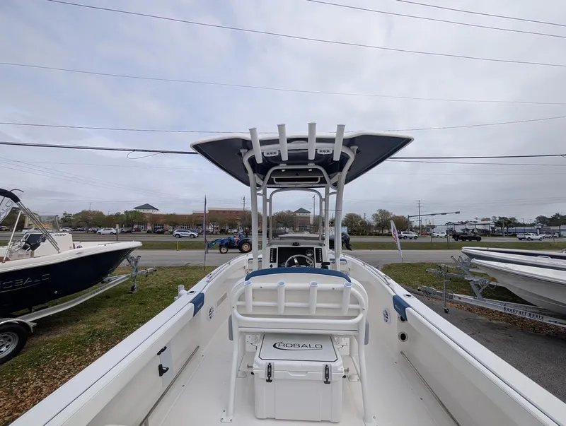 Slide: The Image of 2025 Robalo R222 Explorer boat with T-top, parked outdoors. - 35