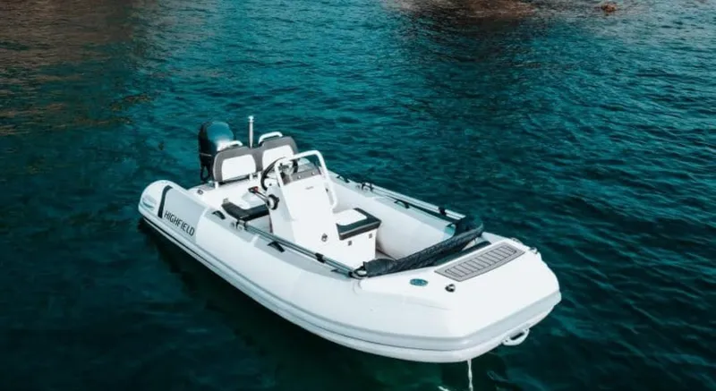 Slide: The Image of 2025 Highfield Sport 360 boat on clear blue water, showcasing sleek design and modern features. - 4