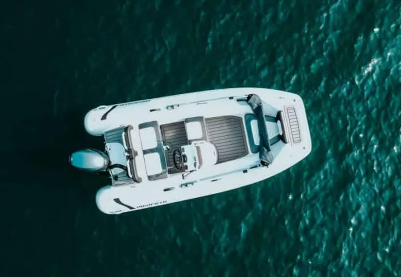 Slide: The Image of 2025 Highfield Sport 360 boat on clear blue water, aerial view. - 6