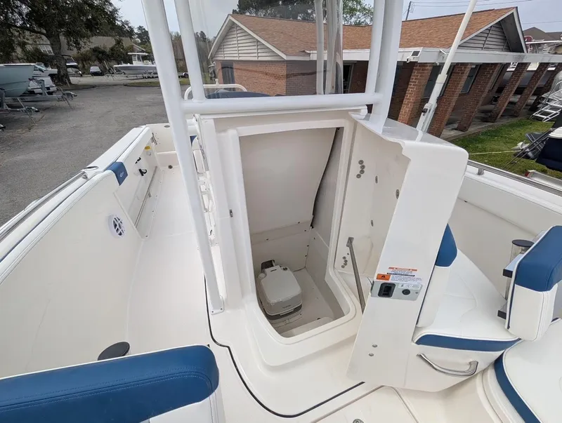 Slide: The Image of 2025 Robalo R222 Explorer boat interior with open storage compartment and seating. - 25
