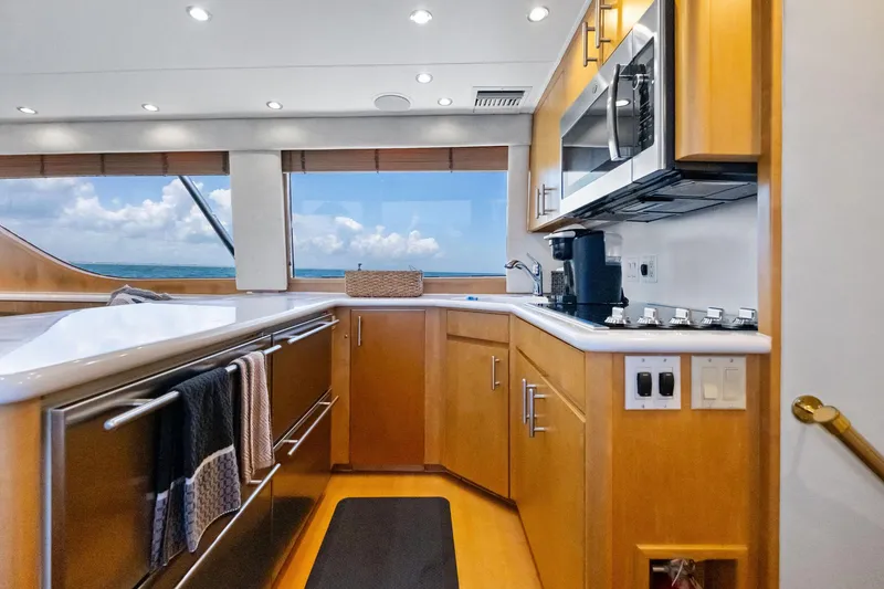 Slide: The Image of Luxurious kitchen interior of 1998 Hatteras 60 Convertible yacht with ocean view. - 34
