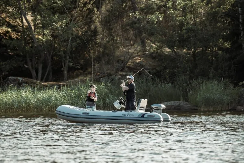 Slide: The Image of Two people fishing on a 2024 Highfield Classic 380 GT boat. - 6