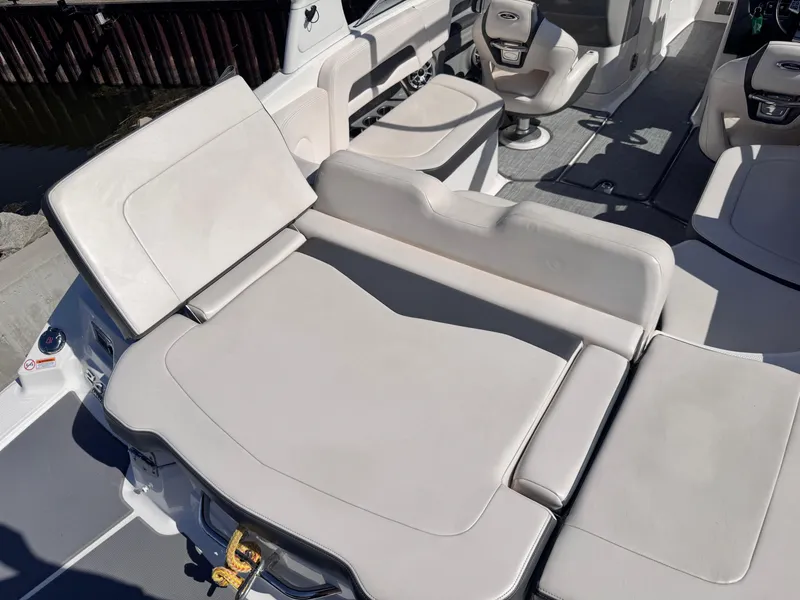 Slide: The Image of 2017 Chaparral 246 SSi boat interior with steering wheel and cushioned seating. - 15